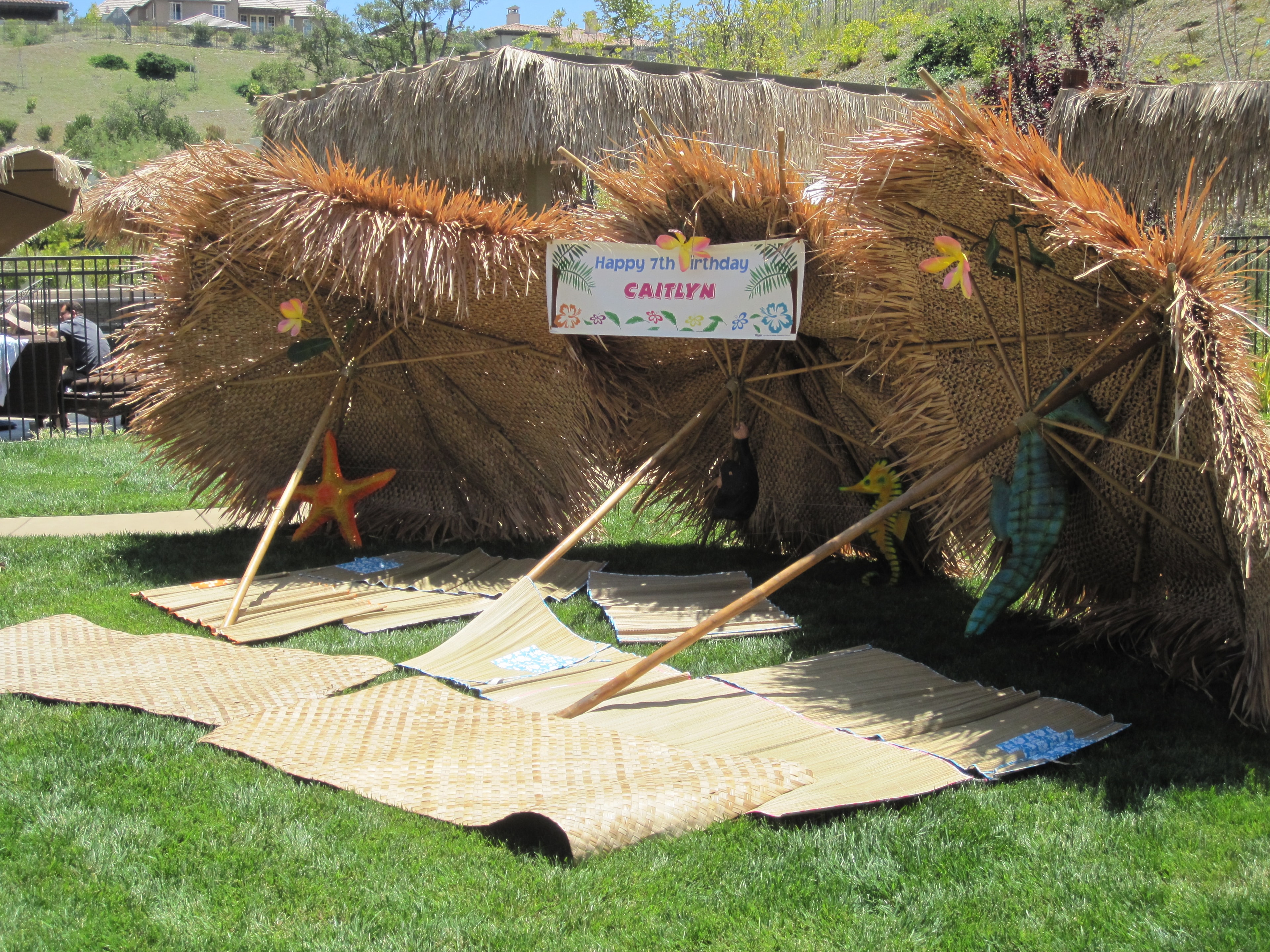 Manea Events tiki hut setup with birthday banner at backyard luau